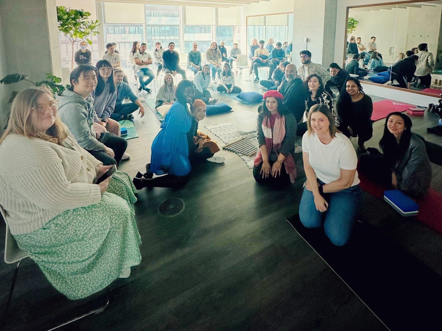 The Intuit team in their Toronto office after a sound bath, smiling at the camera
