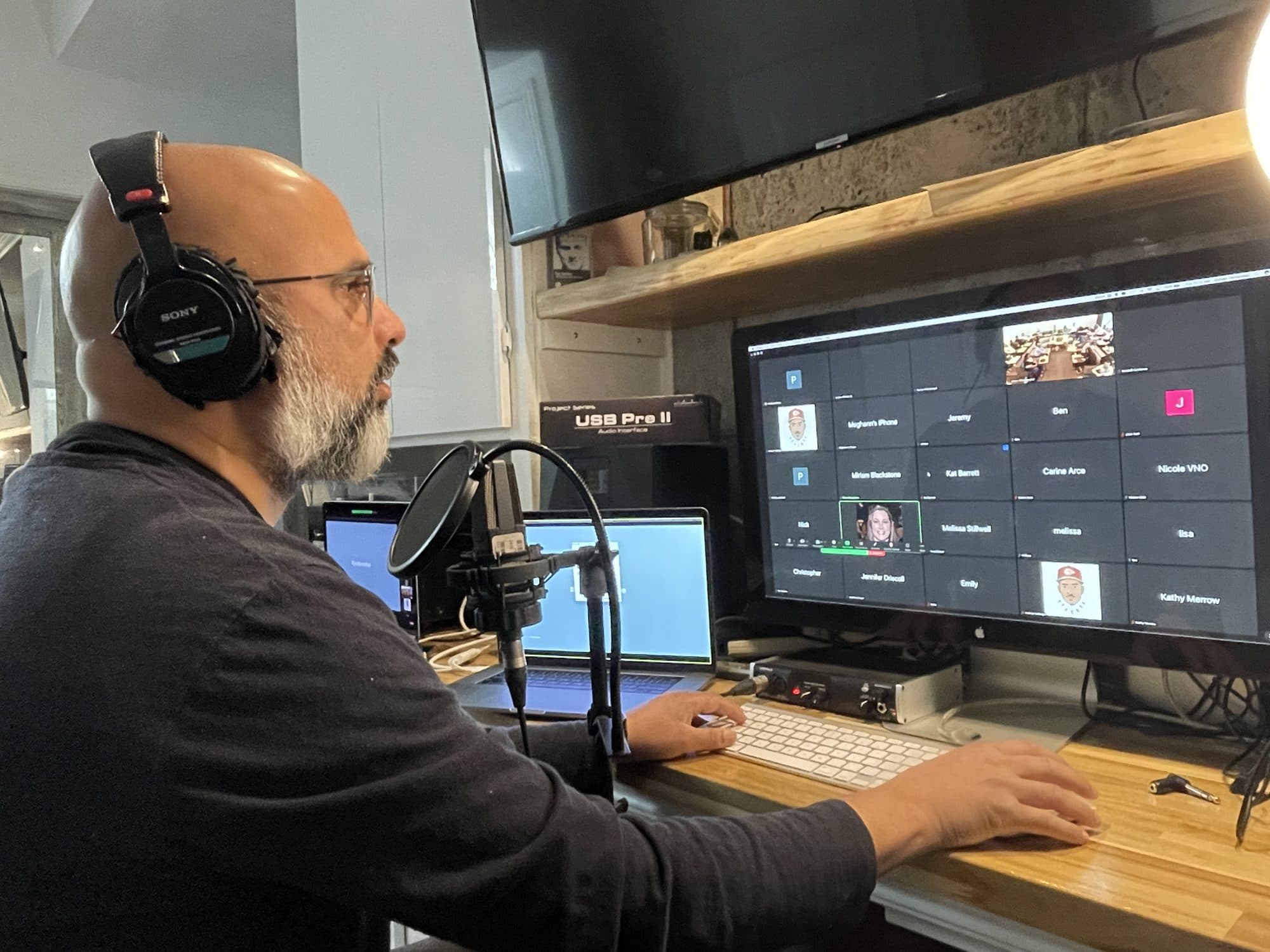 Steve at the studio desk in headphones, playing a live sound bath over Zoom
